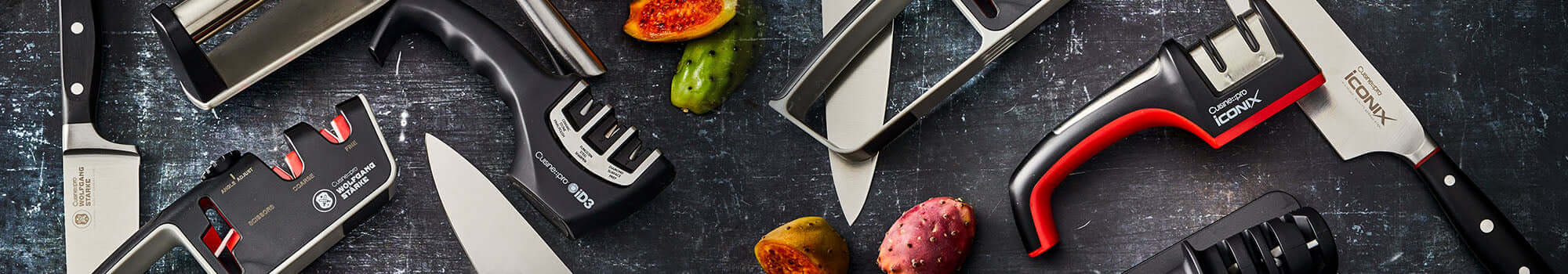 High-quality knife sharpeners and knives on a dark background with fresh produce.