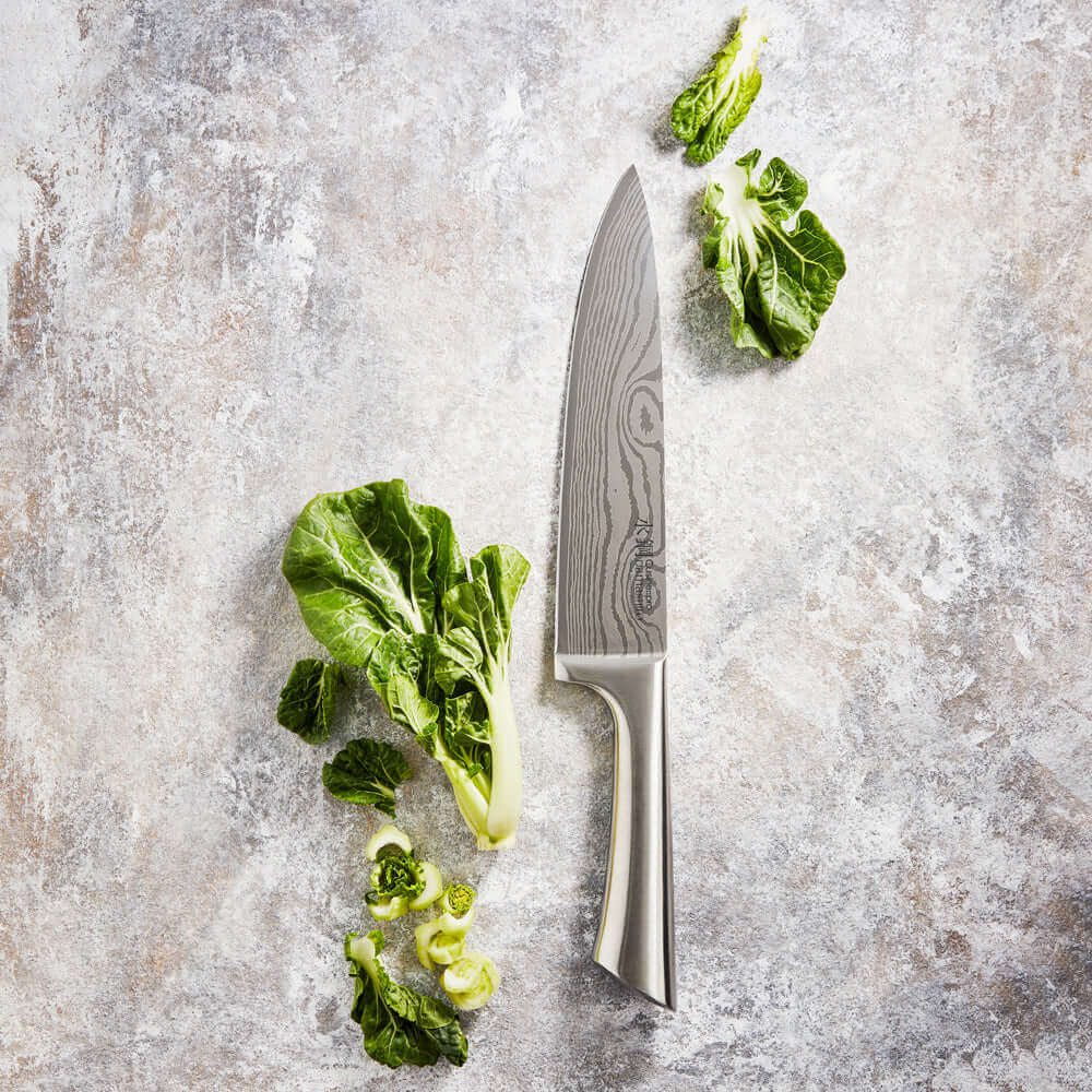 Cuisine::pro® Damashiro® Chefs Knife 20cm 8in with leafy greens on a cutting board