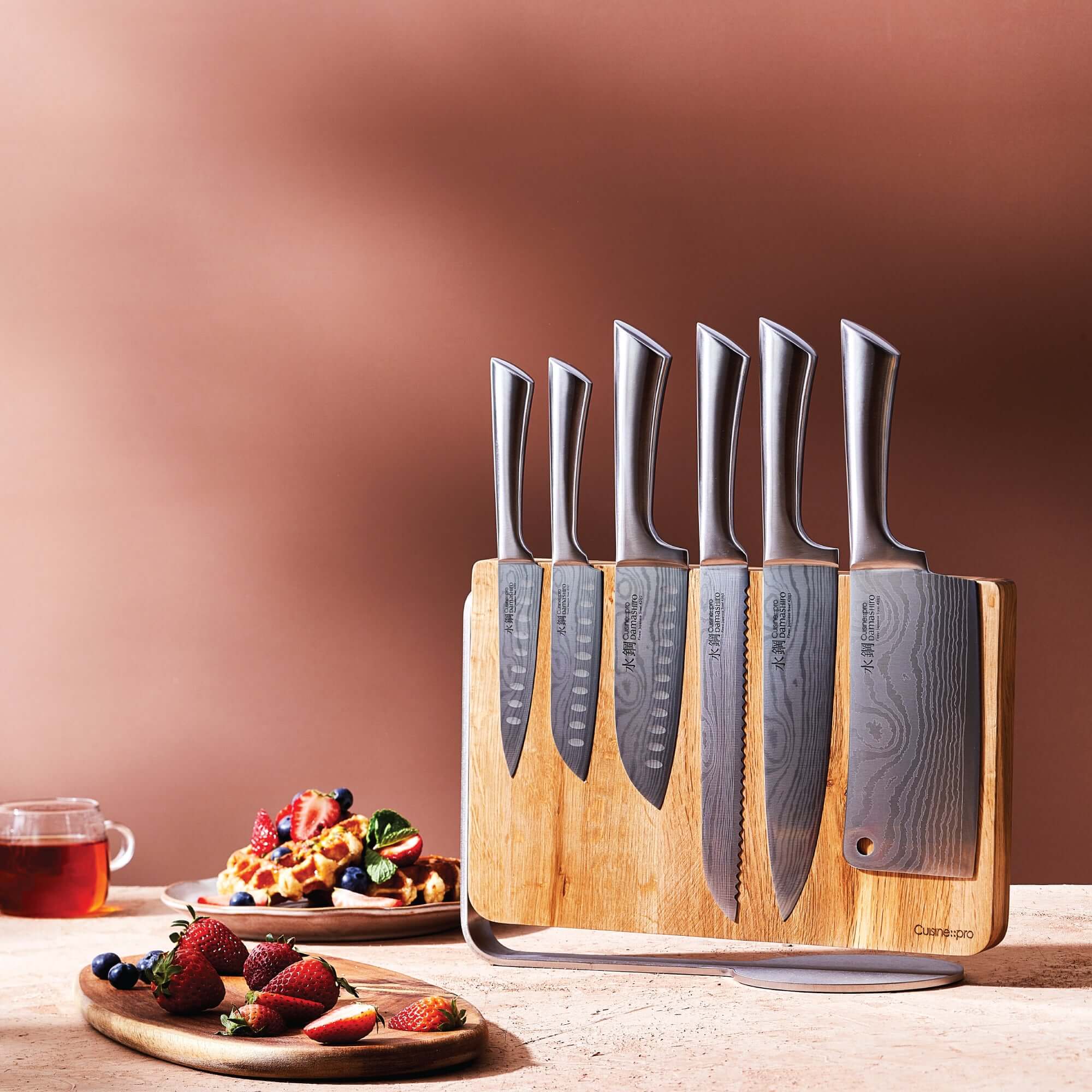 Cuisine::pro® Damashiro® Meiyo 7 piece knife block with six Japanese steel knives and food display in a contemporary setting