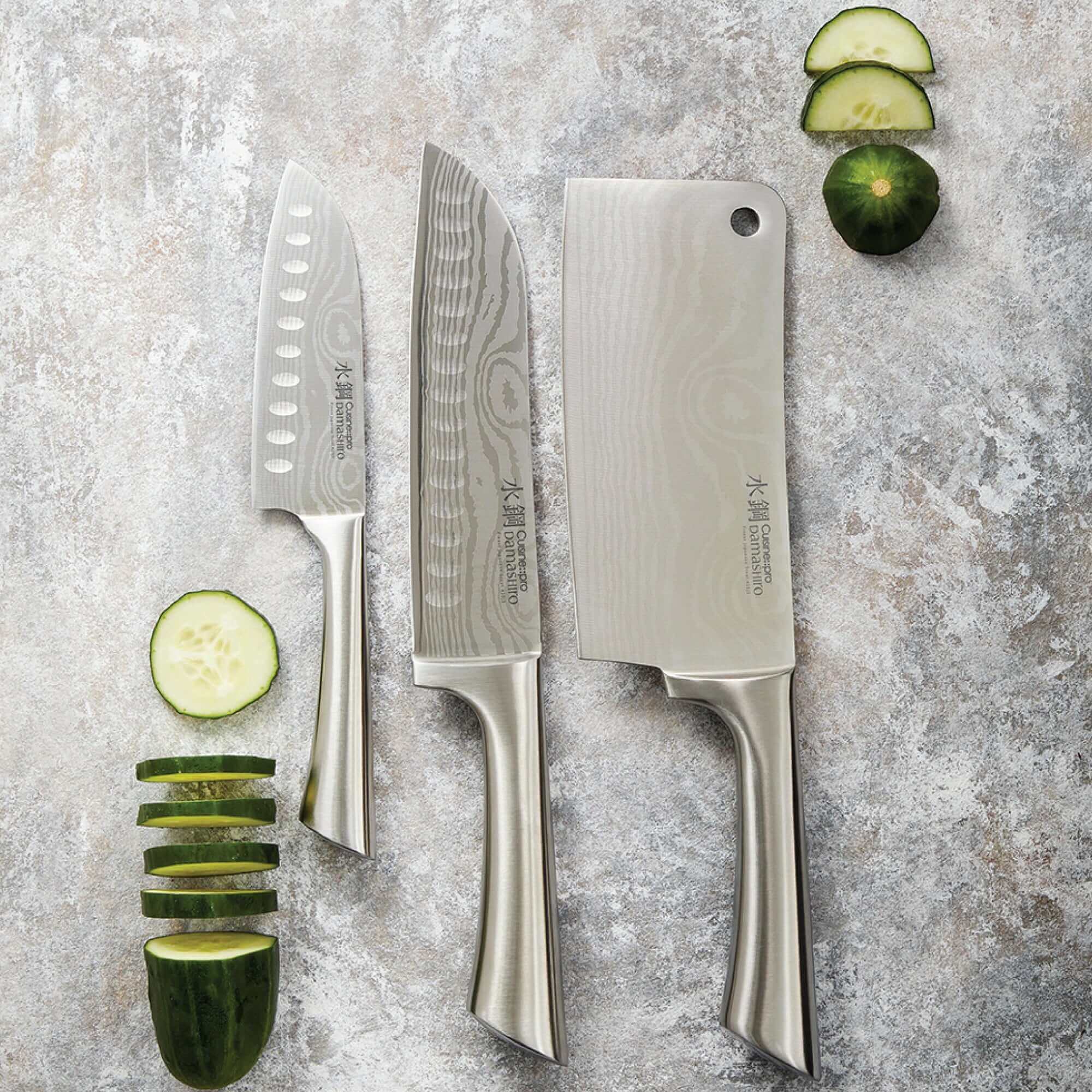 Cuisine::pro® Damashiro® Ultimate Knife Set of 3 with sliced cucumbers on marble background