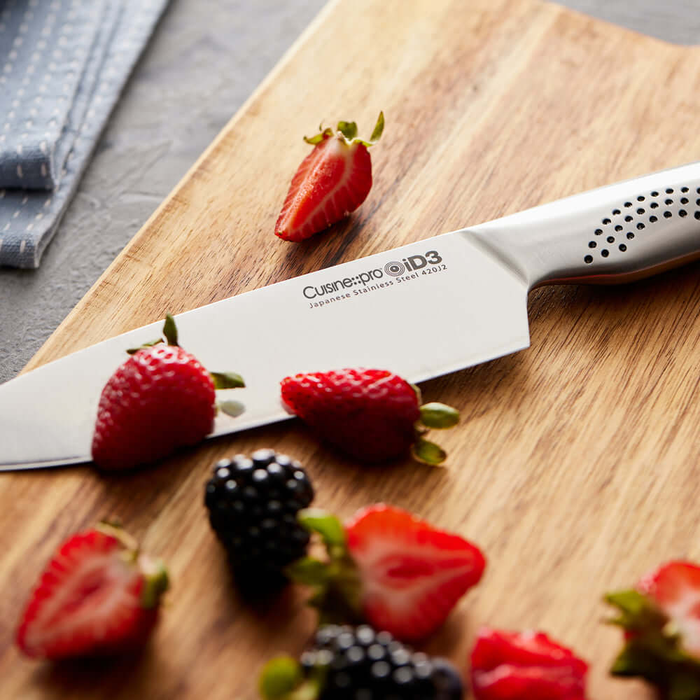 Cuisine::pro® iD3® Chefs Knife 6-inch on cutting board with fresh strawberries and blackberries