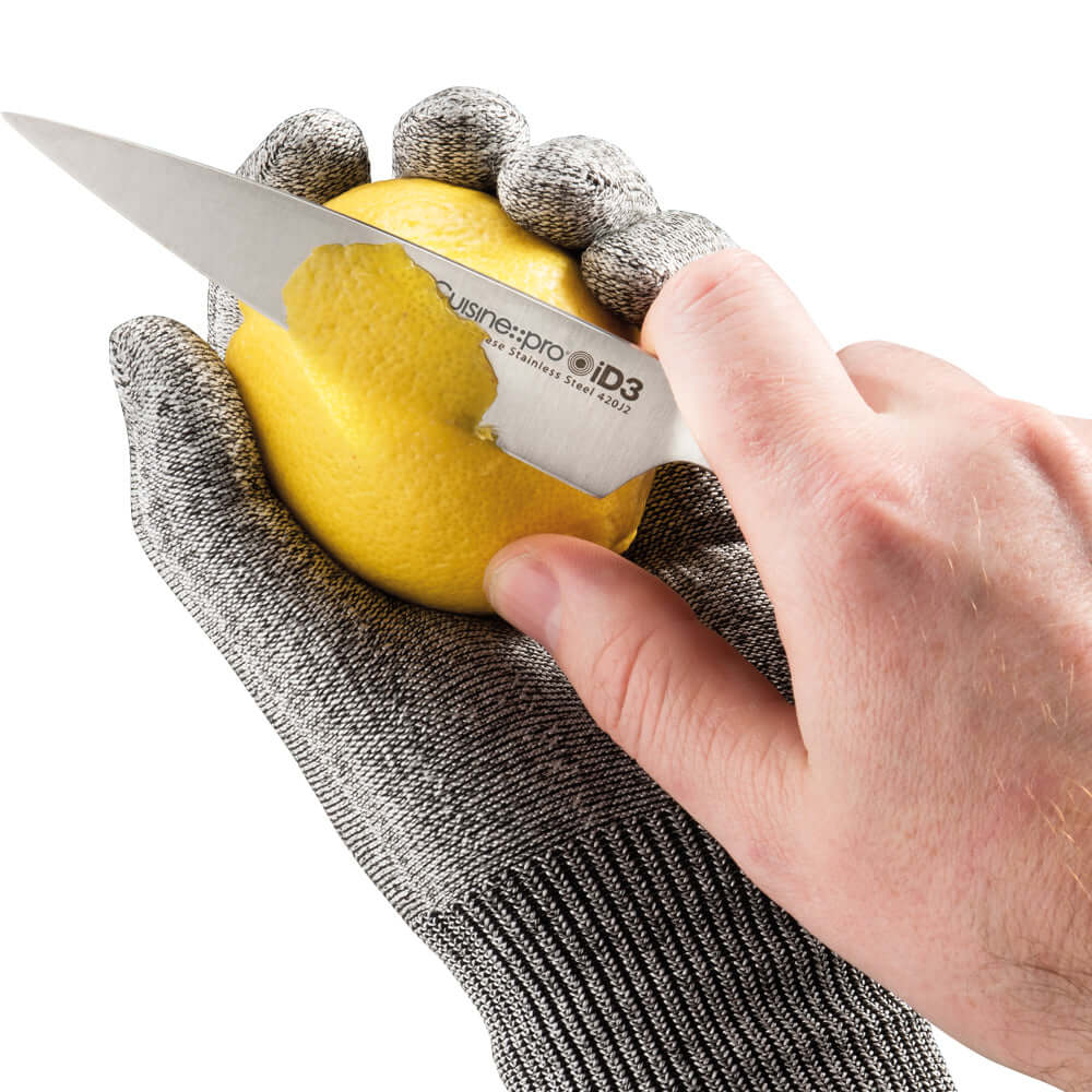 Person wearing Cuisine::pro® iD3® Resistant Glove cutting a lemon with a Cuisine::pro® iD3® knife.