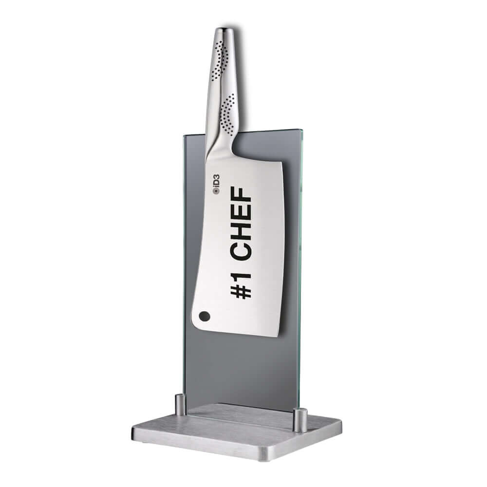 Sleek magnetic knife block with #1 Chef knife on display, tempered glass body, and brushed stainless steel base from THE CUSTOM CHEF™
